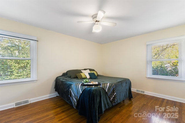 bedroom with dark hardwood / wood-style floors and ceiling fan