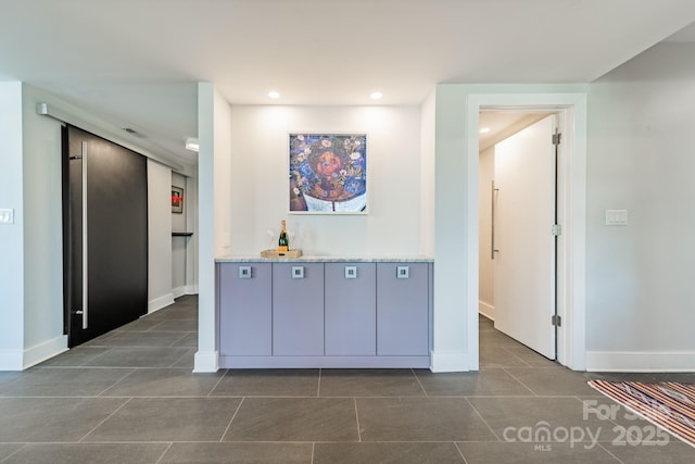 corridor featuring dark tile patterned flooring