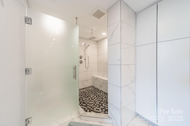 bathroom with a shower with door