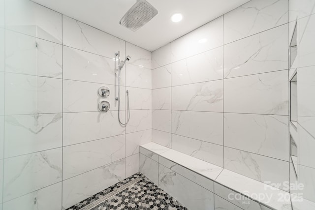 bathroom with a tile shower