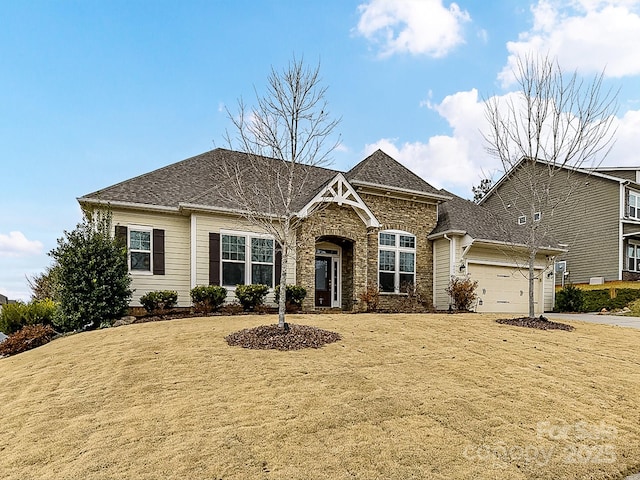 view of front of home with a garage and a front lawn