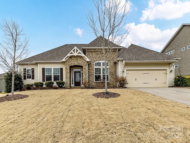 view of front of house with a garage and a front lawn