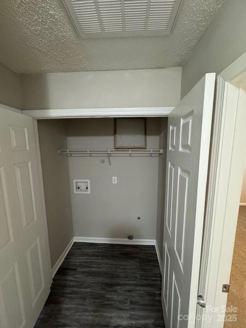 clothes washing area featuring laundry area, visible vents, baseboards, dark wood-type flooring, and hookup for a washing machine