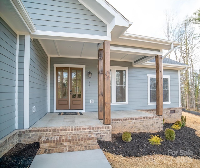 property entrance with french doors and a porch