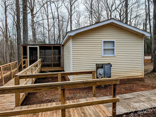 rear view of property with a wooden deck