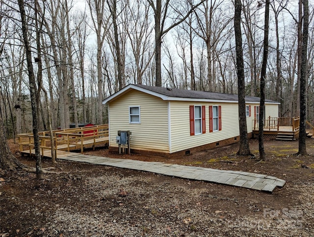 view of property exterior featuring a wooden deck