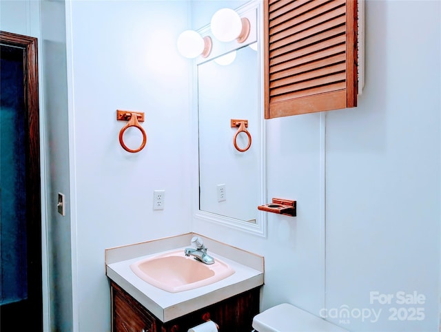 bathroom with toilet and vanity