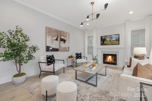 living room with crown molding and light hardwood / wood-style flooring