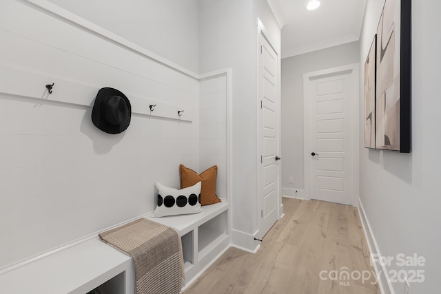 mudroom with crown molding and light hardwood / wood-style flooring