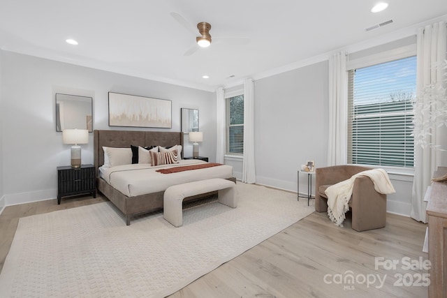 bedroom featuring ornamental molding, ceiling fan, and light wood-type flooring