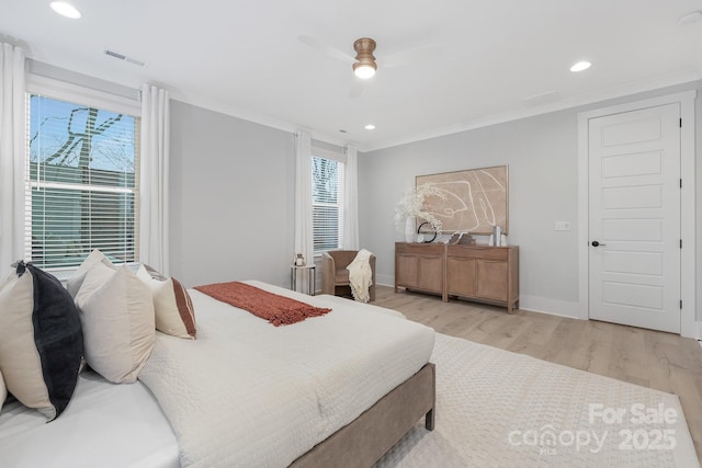 bedroom with ornamental molding, ceiling fan, and light hardwood / wood-style floors