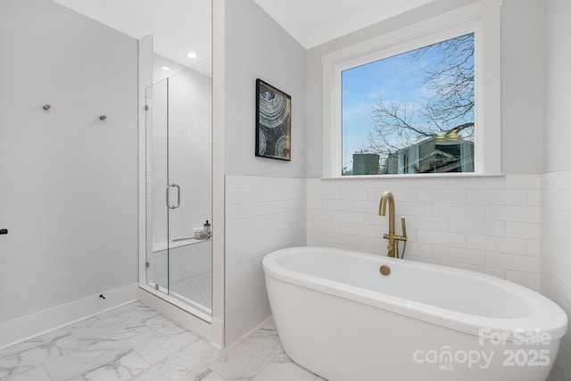 bathroom featuring separate shower and tub and tile walls