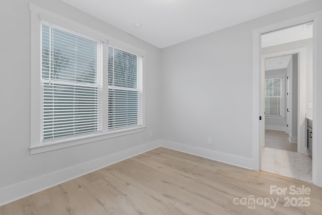 spare room with light hardwood / wood-style flooring