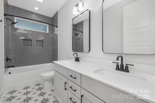 full bathroom featuring vanity, toilet, and tiled shower / bath combo