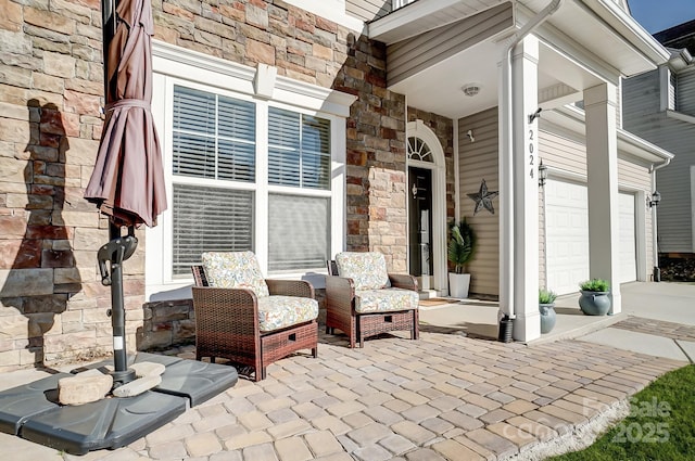 view of patio / terrace with a garage and driveway