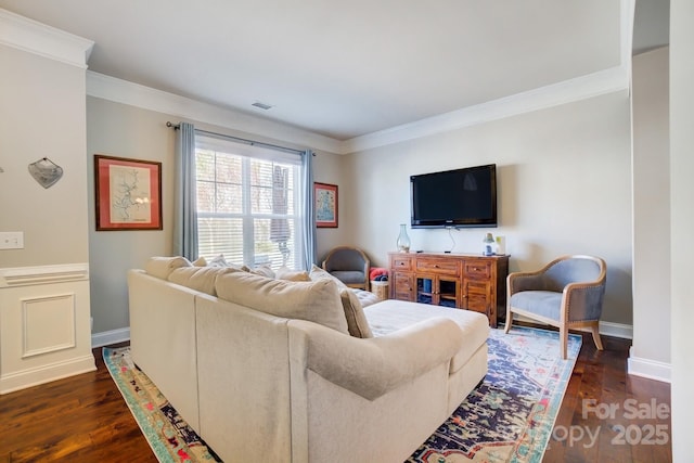 living room featuring baseboards, visible vents, dark wood finished floors, and crown molding