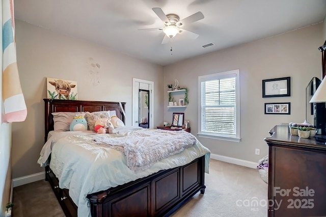 bedroom with light carpet, a ceiling fan, visible vents, and baseboards