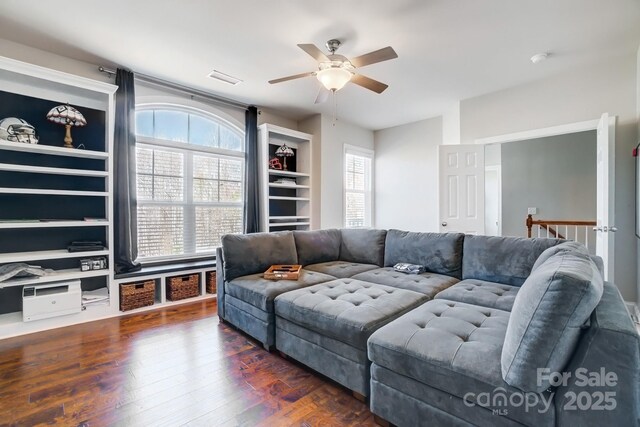 living room featuring a ceiling fan, visible vents, and wood finished floors