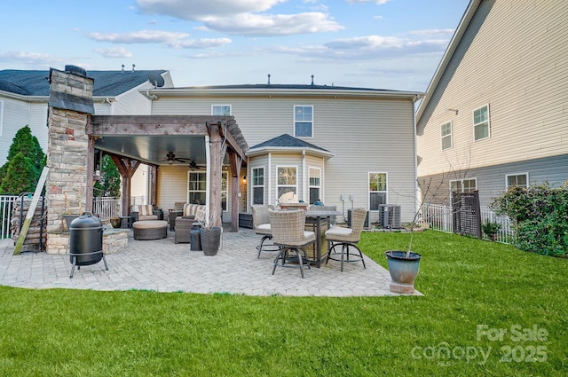 rear view of property featuring a lawn, ceiling fan, fence, cooling unit, and a patio area