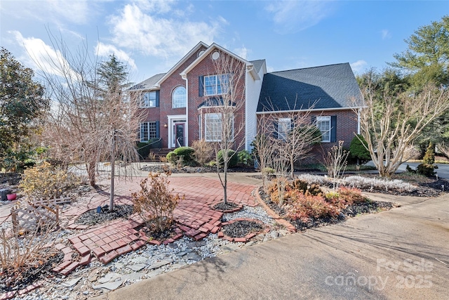 traditional-style house featuring brick siding