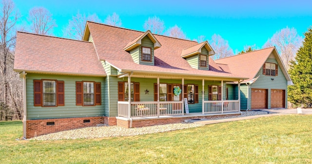 cape cod home featuring a porch, a garage, and a front yard