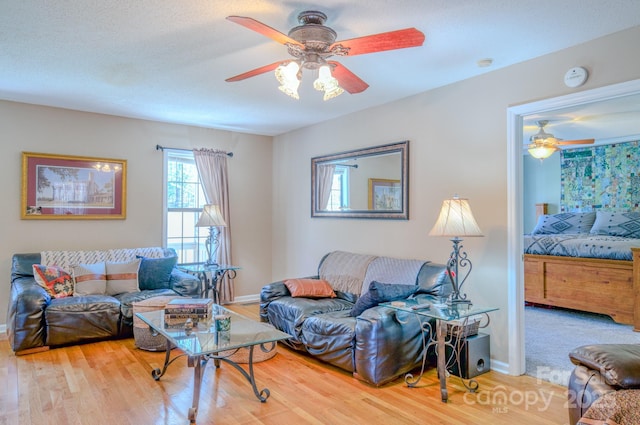 living room with hardwood / wood-style floors and ceiling fan