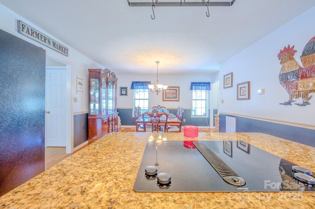 dining area featuring an inviting chandelier and hardwood / wood-style floors