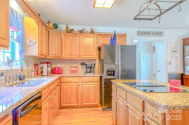 kitchen featuring black appliances, sink, decorative backsplash, light stone counters, and light hardwood / wood-style floors