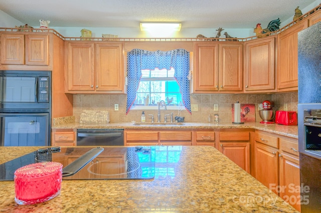 kitchen featuring sink, decorative backsplash, black appliances, and a textured ceiling