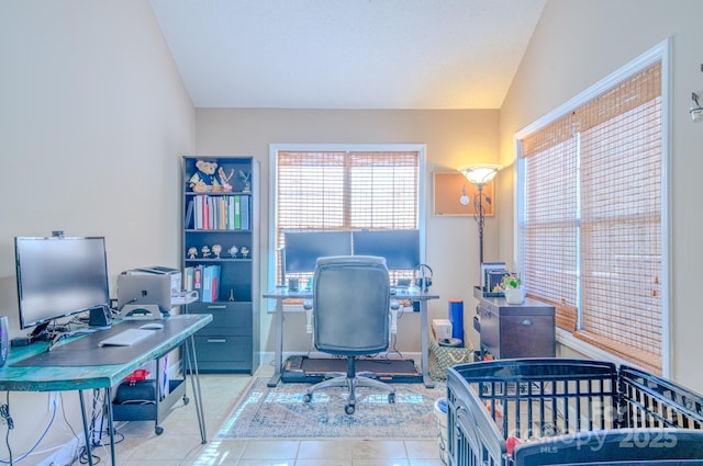 tiled office featuring vaulted ceiling