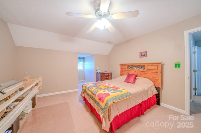 carpeted bedroom with ceiling fan and vaulted ceiling