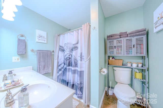 bathroom with vanity, toilet, and curtained shower