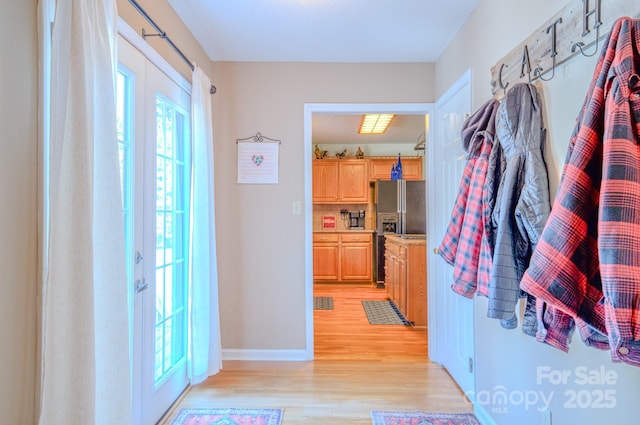 interior space with french doors and light hardwood / wood-style flooring