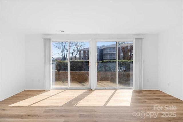 unfurnished room with light hardwood / wood-style flooring