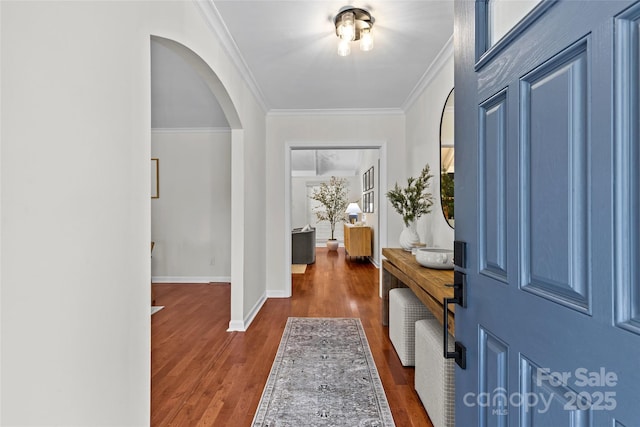 foyer entrance with dark hardwood / wood-style flooring and ornamental molding