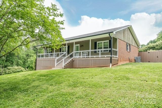 6108 Gold Creek Estate Dr, Hickory, NC 28601 - view of front facade with a porch, a front lawn, stairway, and board and batten siding