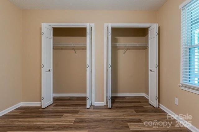 6108 Gold Creek Estate Dr, Hickory, NC 28601 - unfurnished bedroom with two closets and dark wood-style flooring
