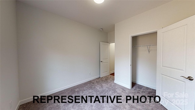 unfurnished bedroom with carpet flooring, baseboards, and a closet