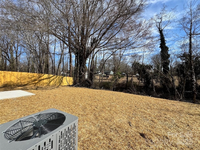 view of yard with cooling unit and fence