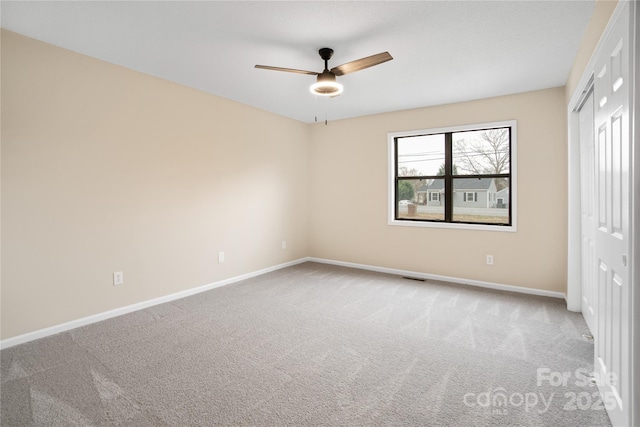 unfurnished bedroom featuring ceiling fan, carpet floors, and a closet