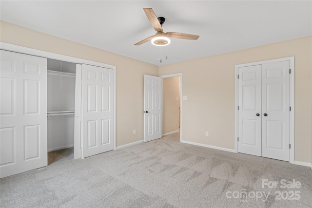 unfurnished bedroom with light colored carpet and ceiling fan