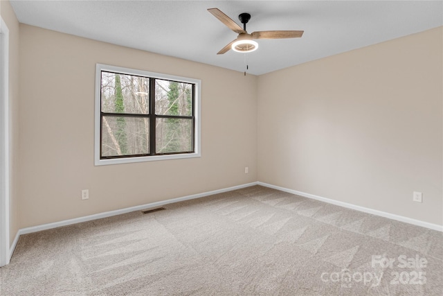 spare room with ceiling fan and carpet flooring