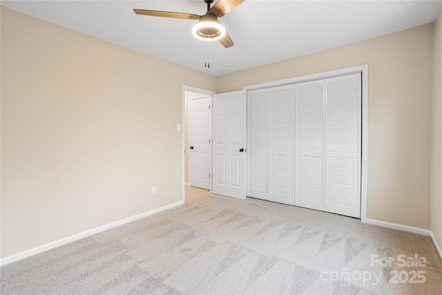 unfurnished bedroom with light carpet, a closet, and ceiling fan