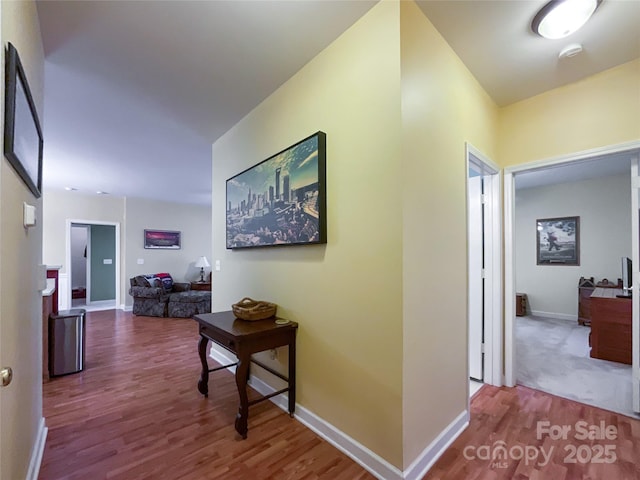 corridor with hardwood / wood-style floors