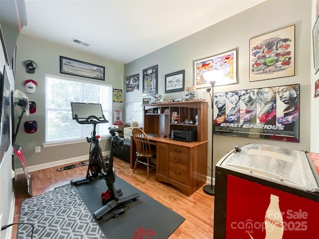 workout area with hardwood / wood-style floors