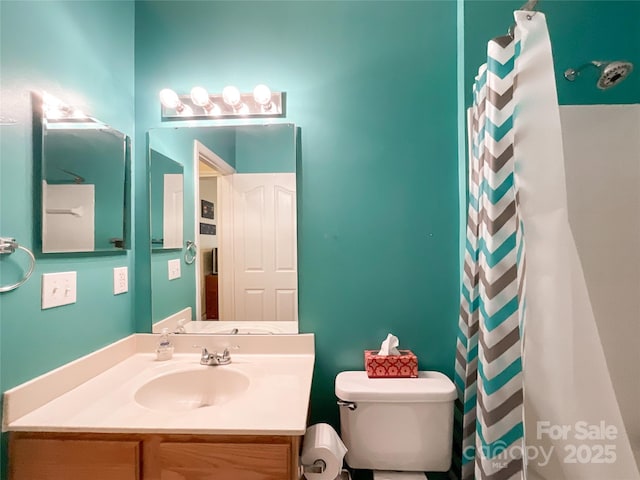 bathroom with walk in shower, vanity, and toilet