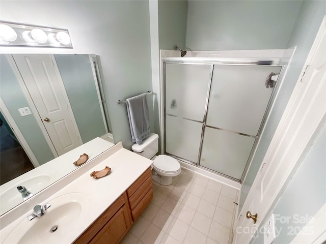 bathroom featuring an enclosed shower, vanity, and toilet