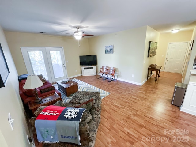 living room featuring ceiling fan and light wood-type flooring