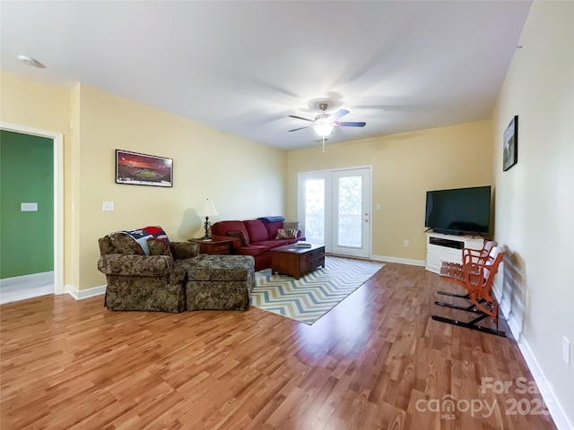 living room featuring hardwood / wood-style floors and ceiling fan