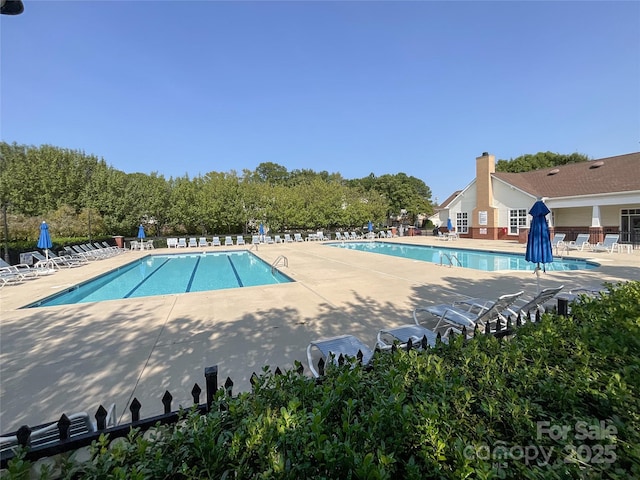 view of swimming pool featuring a patio area